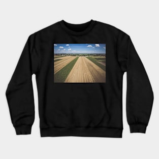 Aerial view of round hay bales on stubble under blue cloudy sky Crewneck Sweatshirt